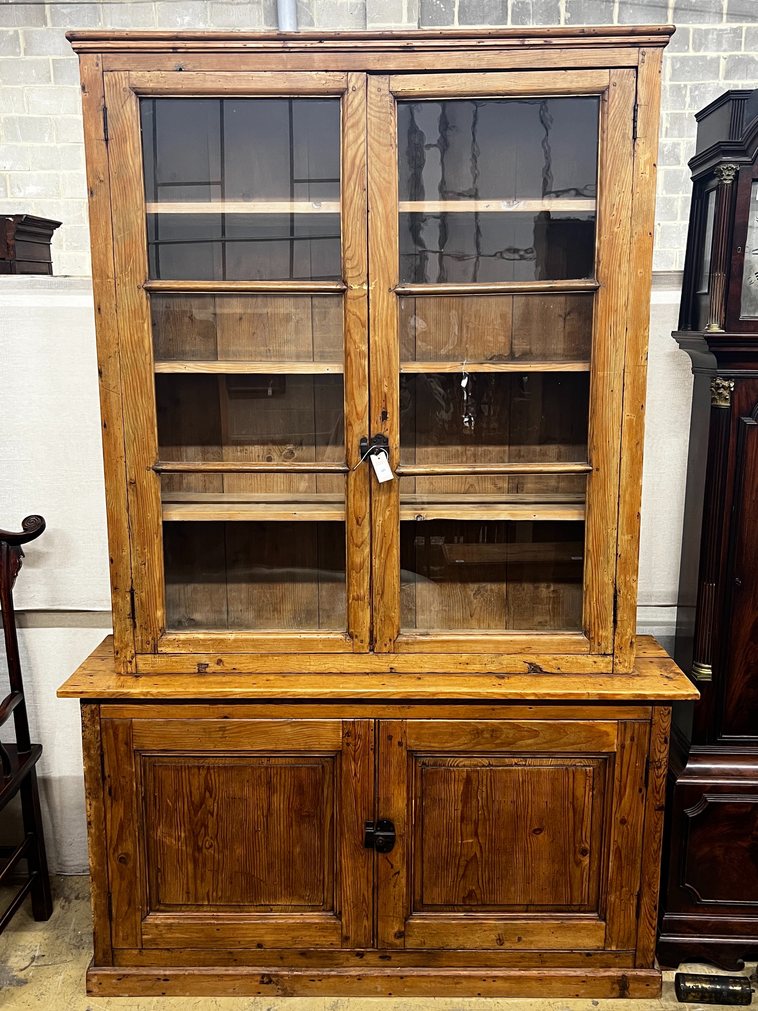 A 19th century French provincial pine two door glazed bookcase, length 151cm, depth 39cm, height 229cm